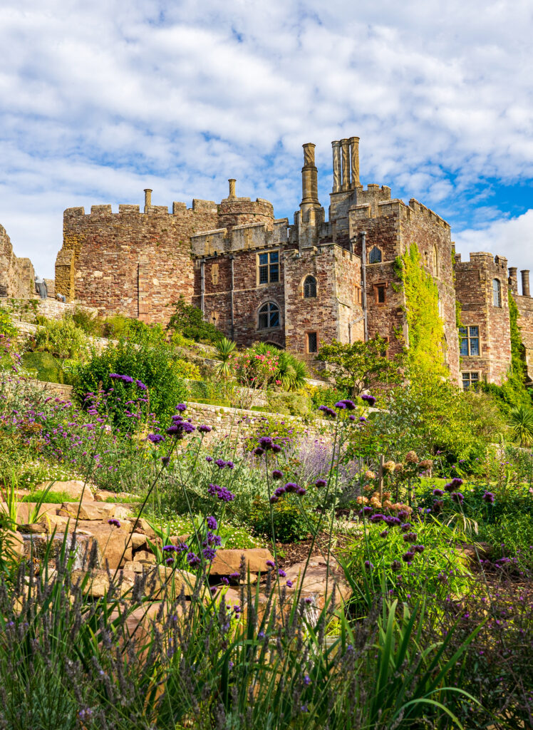 The beautiful Berkeley Castle gardens in the foreground with the castle in the background.le