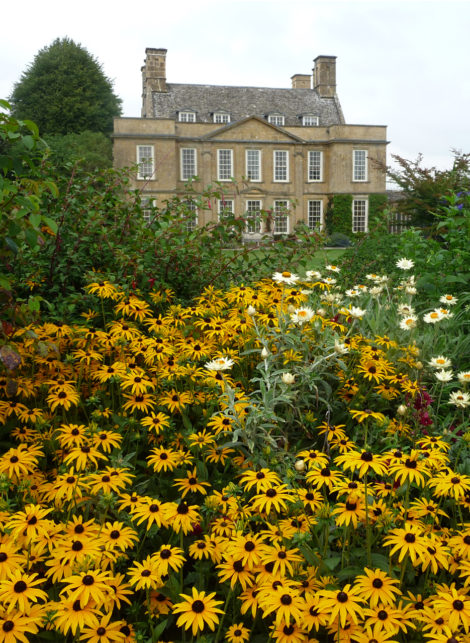 The beautiful gardens of Bourton House with the house in the background.