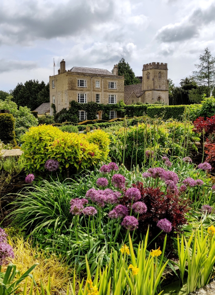 A view of the beautiful gardens with Daglingworth House in the background.