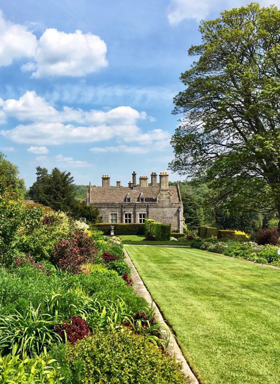 A view across the beautiful gardens with Miserden Park House in the background.