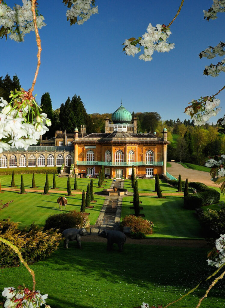 A view of the iconic Sezincote House across formal gardens.