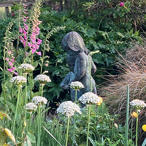 A statue of a small girl in Rockcliffe gardens.