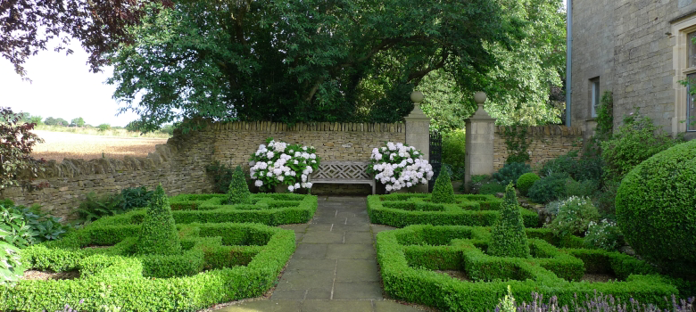 A view of the pristine courtyard with formal box topiary.